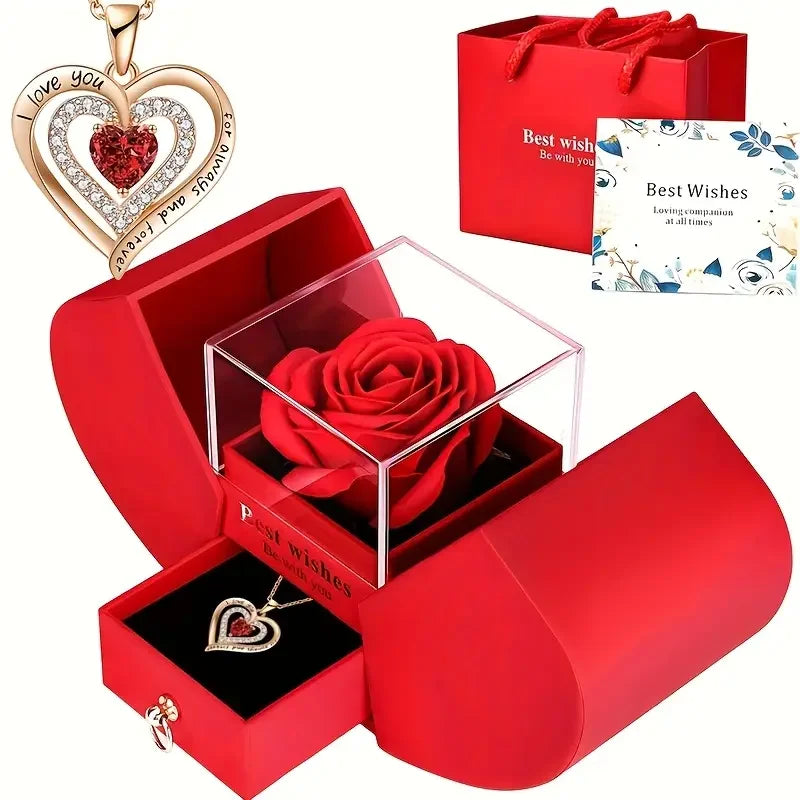 A red velvet box containing an elegant rose pendant necklace and a greeting card for best wishes