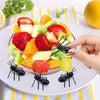 Reusable ant-shaped plastic toothpicks and fruit forks used for serving party snacks like fruit