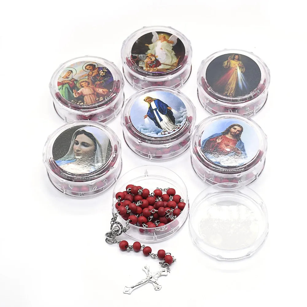 A set of scented wood bead crucifix necklaces and various small glass containers.