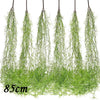 A bundle of artificial green plant vines hanging down, used as a wall decoration.
