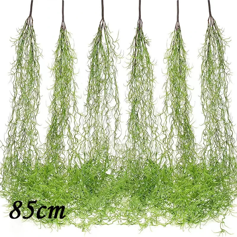 A bundle of artificial green plant vines hanging down, used as a wall decoration.
