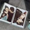 A clear photo album with two photos of a couple, featuring close-up portraits and affectionate poses.