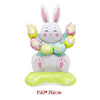 A white cartoon bunny decoration made of foil balloons with pink accents and a green base.