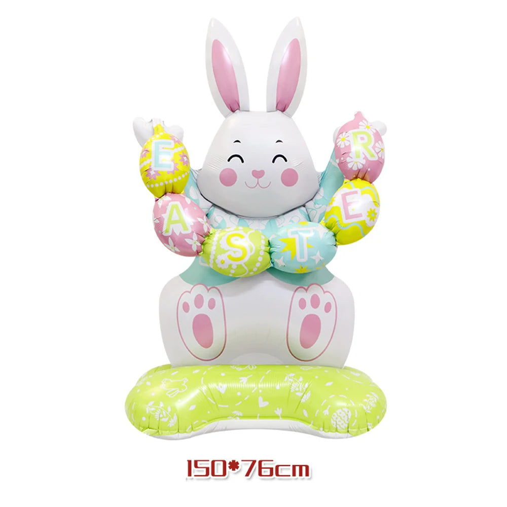A white cartoon bunny decoration made of foil balloons with pink accents and a green base.