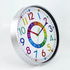 A round, colorful silent wall clock with numbers and hands displaying the time.