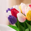 A bouquet of colorful artificial tulips featuring shades of pink, white, yellow, and purple.