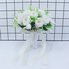 Elegant white silk rose bridal bouquet tied with a sheer ribbon against a black and white grid background