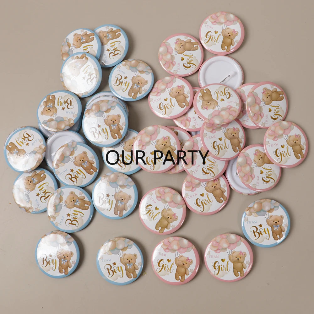 A collection of round pin badges featuring cartoon bears for gender reveal and baby shower parties