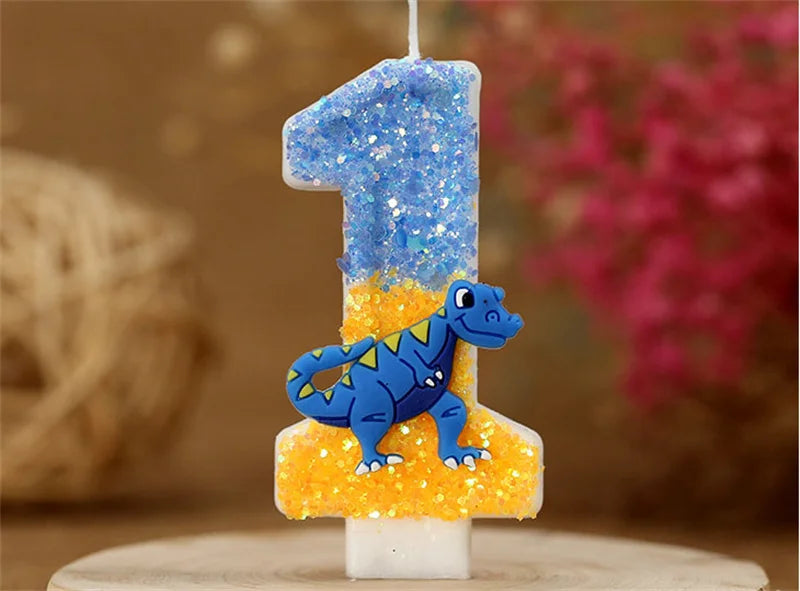 A birthday candle shaped like the number one, decorated with blue glitter and a small dinosaur figure.