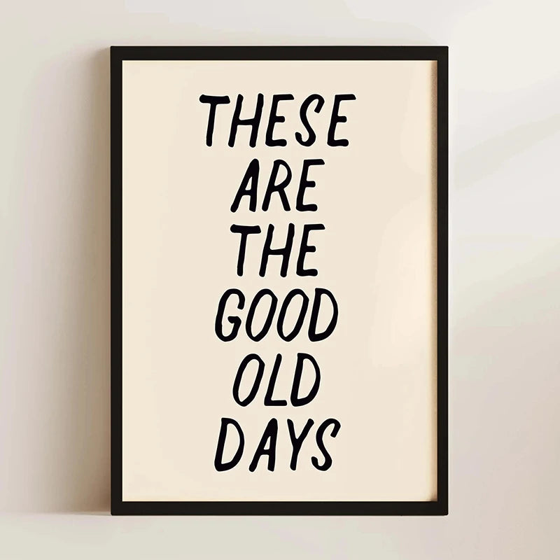 A framed print with black text that reads These are the good old days on a light beige background.