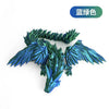 A teal-colored 3D printed articulated dragon fidget figurine with detailed scales and wings.
