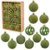 A set of twelve green velvet Christmas hanging ornaments, some striped and some solid, displayed in a cardboard box.