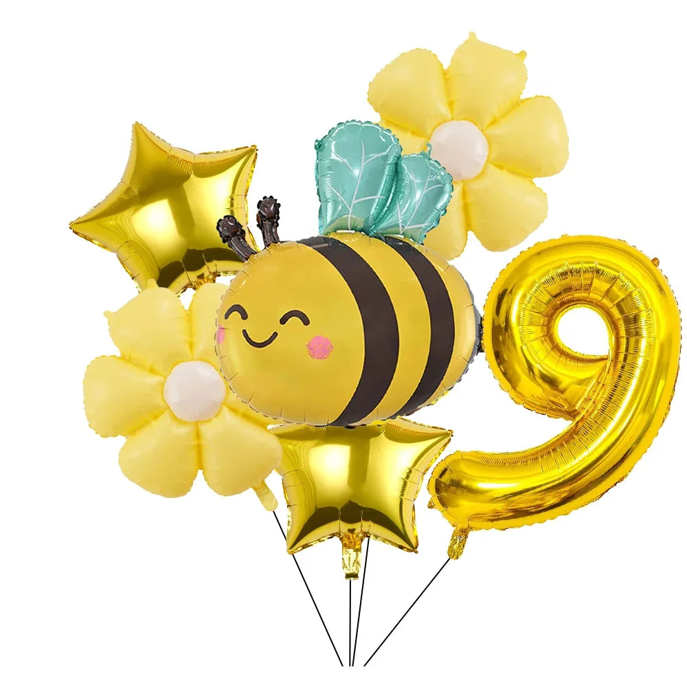 A set of six yellow and gold aluminum foil daisy balloons, including a bee balloon and a large number nine balloon.