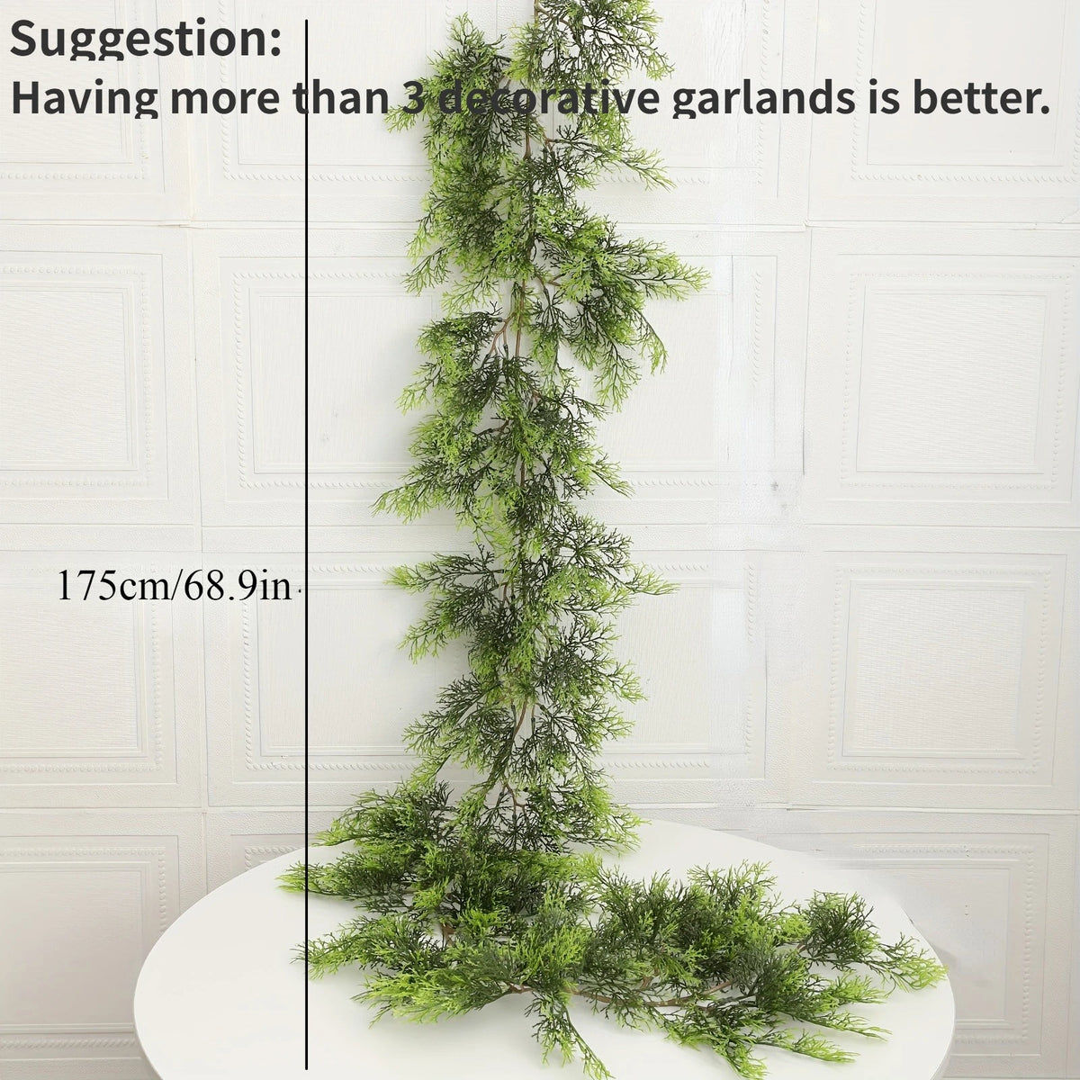 An extra long pine vine wreath used for holiday decor, displayed vertically on a white surface.