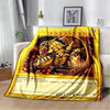 A yellow and gold throw blanket featuring an illustration of the Divine Beast card from Yu-Gi-Oh!