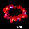 A crown made of red LED flowers with glowing lights against a black background.
