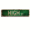 A vintage green metal street sign with the text HIGH ST on it.