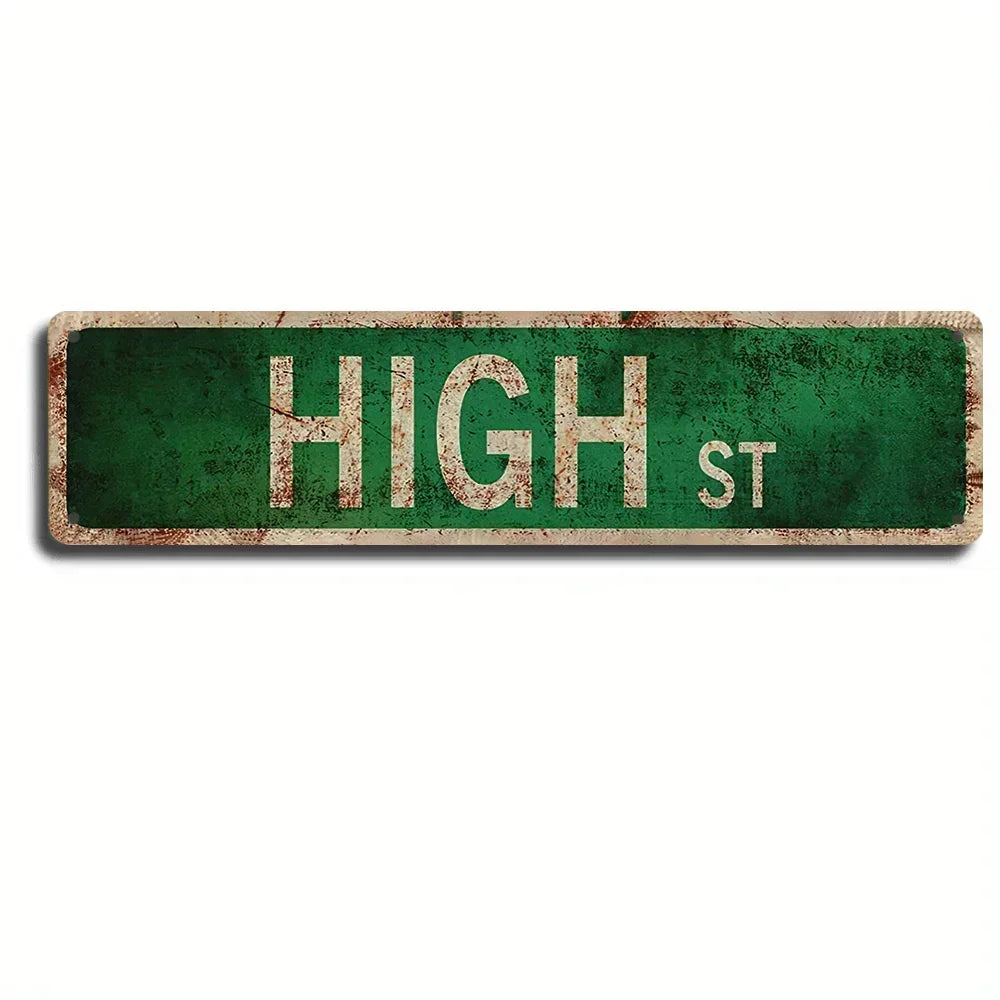 A vintage green metal street sign with the text HIGH ST on it.