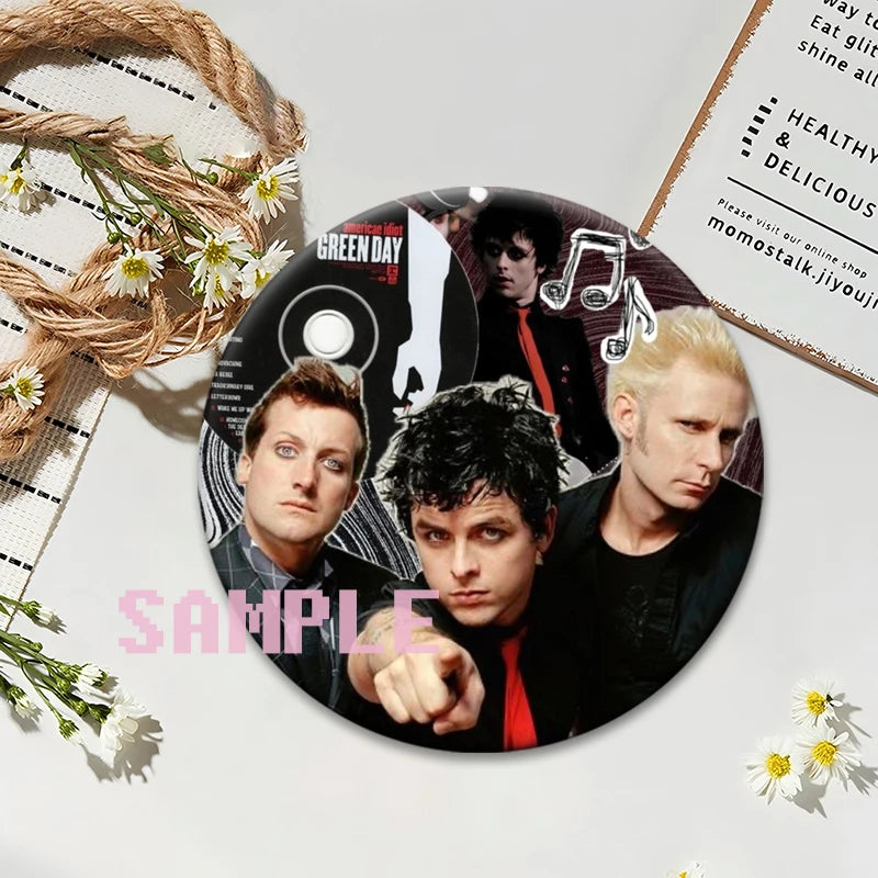 A set of collectible button pins featuring members of the punk band Green Day on an album cover design.