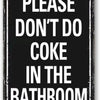 A black metal sign with white text that reads PLEASE DON'T DO COKE IN THE BATHROOM