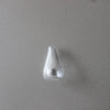 A clear glass fridge magnet shaped like a teardrop or inverted cone against a gray background.