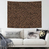 A leopard print tapestry wall hanging displayed above a white sofa with decorative pillows.