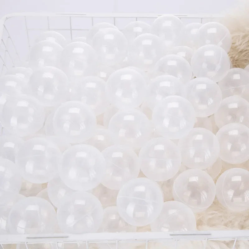 A white basket filled with a large pack of clear, round, bubble-like balls for play.