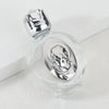 Decorative glass bottle with a silver figurine and twist cap