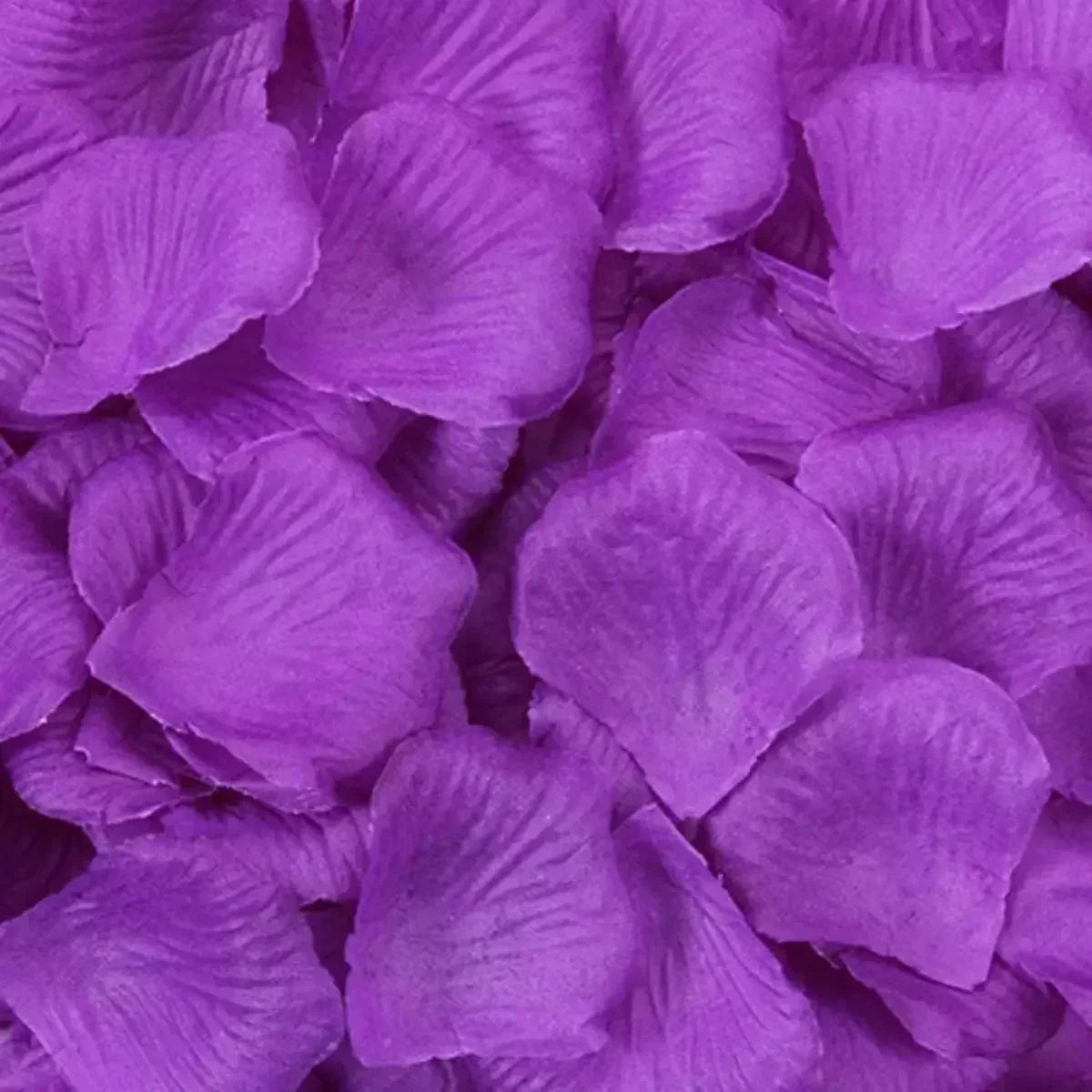 Close-up of purple artificial rose petals used for wedding decoration.