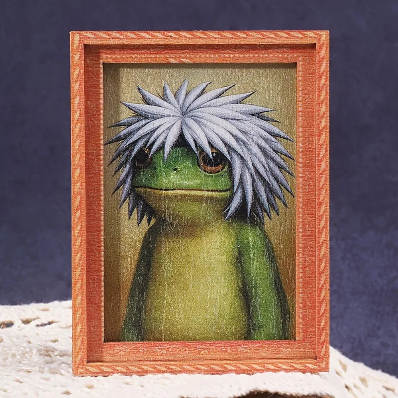 A cute green frog character is displayed inside a wooden photo frame.