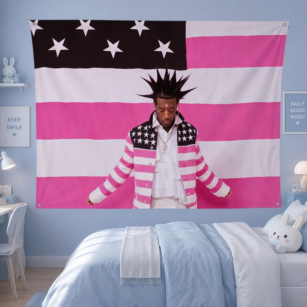 A person wearing a striped jacket stands in front of an American flag banner featuring pink and white stripes and stars.