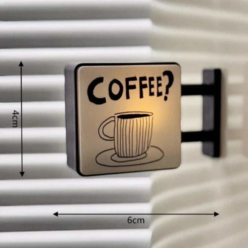 A square magnetic fridge decor featuring the text COFFEE? with a soft glow on a white ribbed surface.