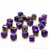 A collection of square cut glass crystal beads in various shades of purple and violet.