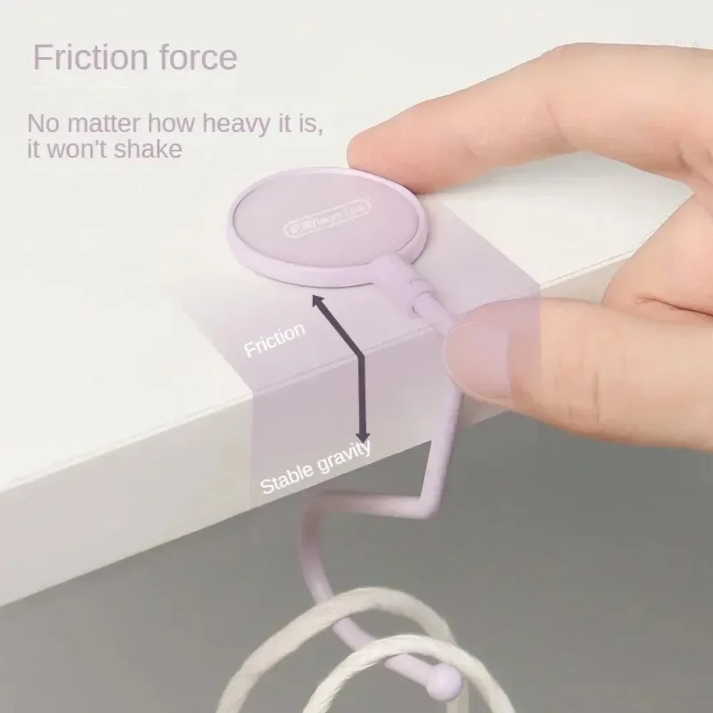 A hand is shown placing a purple silicone hook onto a white surface, demonstrating friction force and stable gravity.