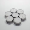 A cluster of six silver-colored tealight candles arranged on a white surface.