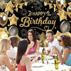 A group of diverse friends celebrating a birthday dinner in front of an elegant black and gold party backdrop.