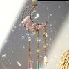 A handcrafted moon crystal suncatcher featuring a pink crystal crescent and dangling prism pendants.