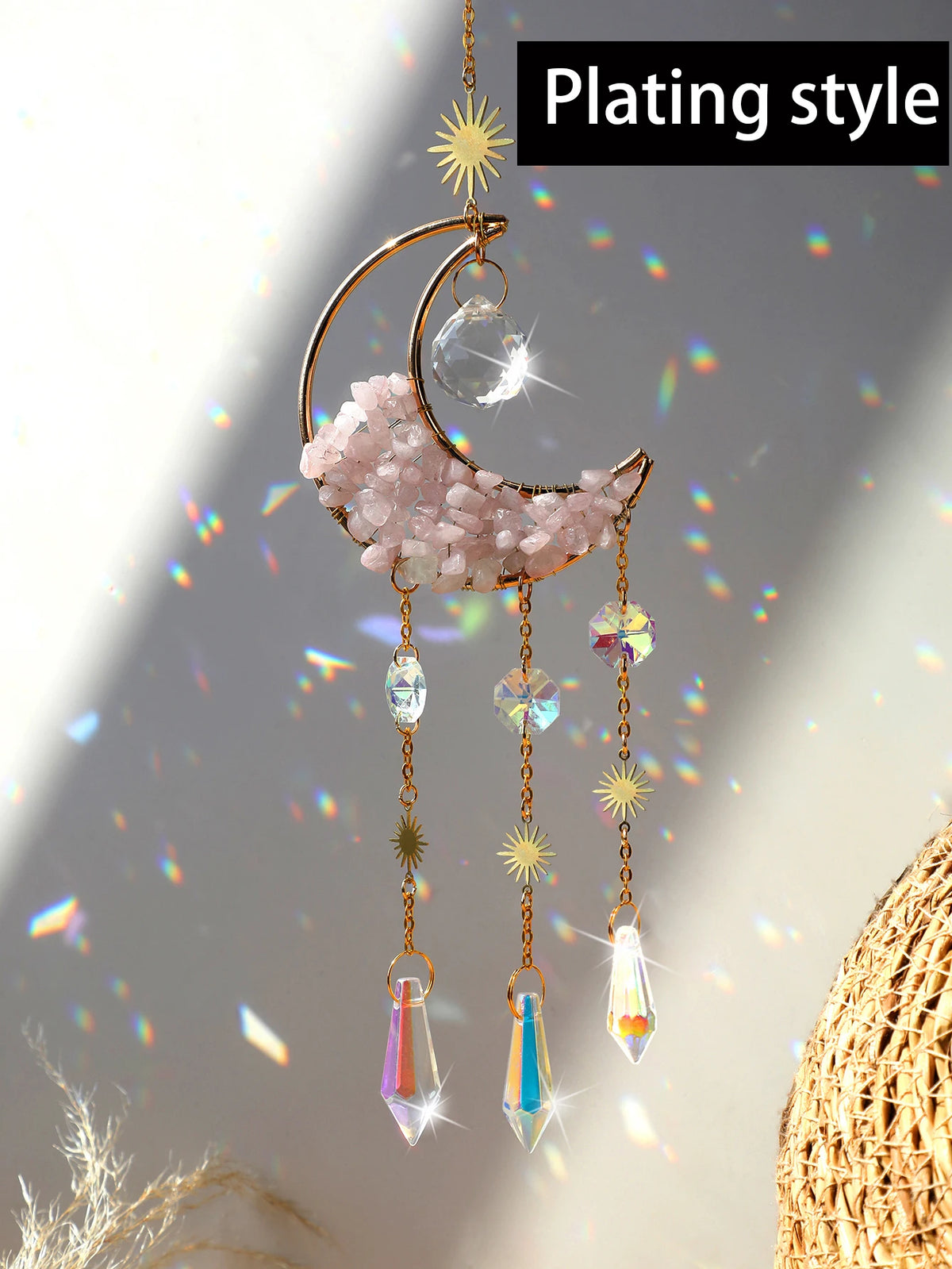 A handcrafted moon crystal suncatcher featuring a pink crystal crescent and dangling prism pendants.
