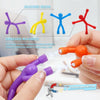Hands demonstrate silicone resin magnets with humanoid figures and embedded magnets for decoration.