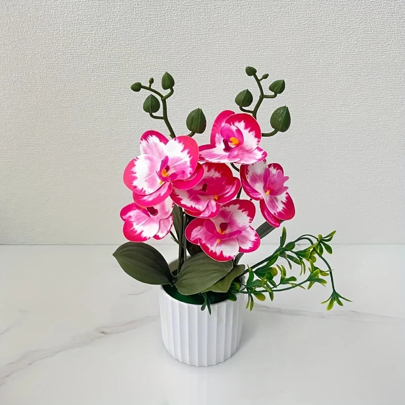 Artificial pink and white phalaenopsis orchid plant in a white pot