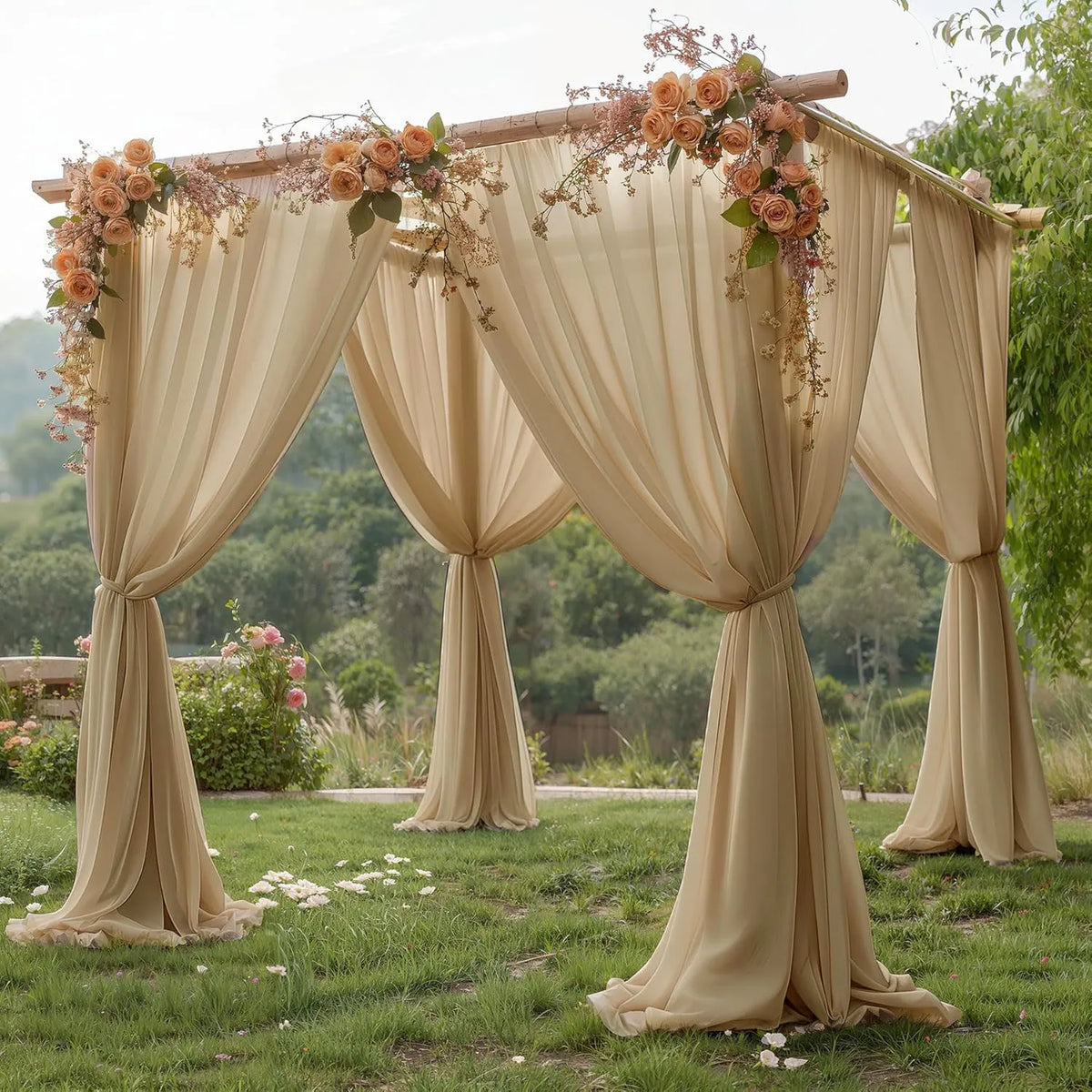 A beige chiffon backdrop curtain draped over a wooden frame for an outdoor wedding or event setting.