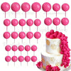 A set of pink foam cake toppers on sticks for decoration