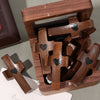 A wooden pocket cross for prayer and reflection is shown inside a wooden box.