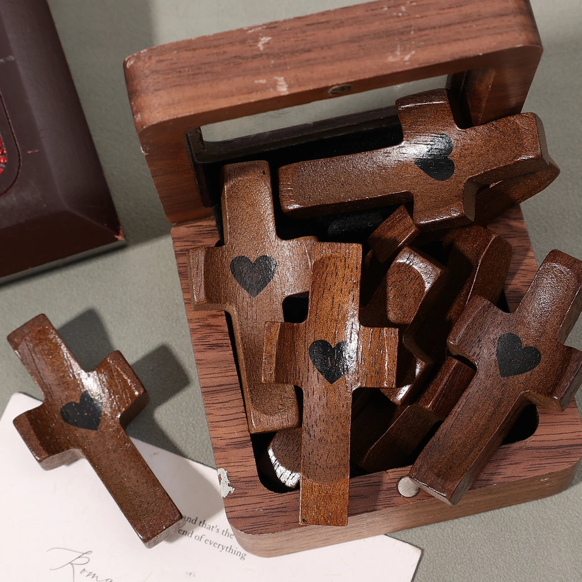 A wooden pocket cross for prayer and reflection is shown inside a wooden box.