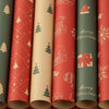 A vertical display of festive Christmas kraft wrapping paper rolls in red and green tones.
