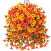 A hanging arrangement of artificial orange and red morning glory flowers with green eucalyptus leaves.