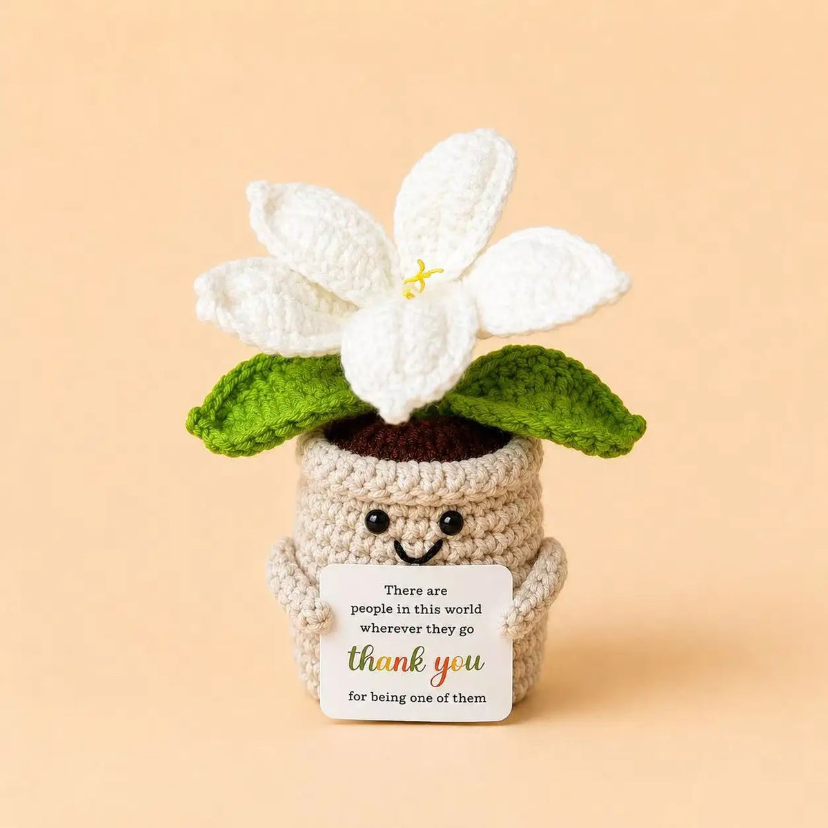 Handcrafted crochet white lily flower pot with a thank you card set against a beige background