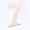 A light wood number display stand shaped like the numeral seven, used for serving desserts.