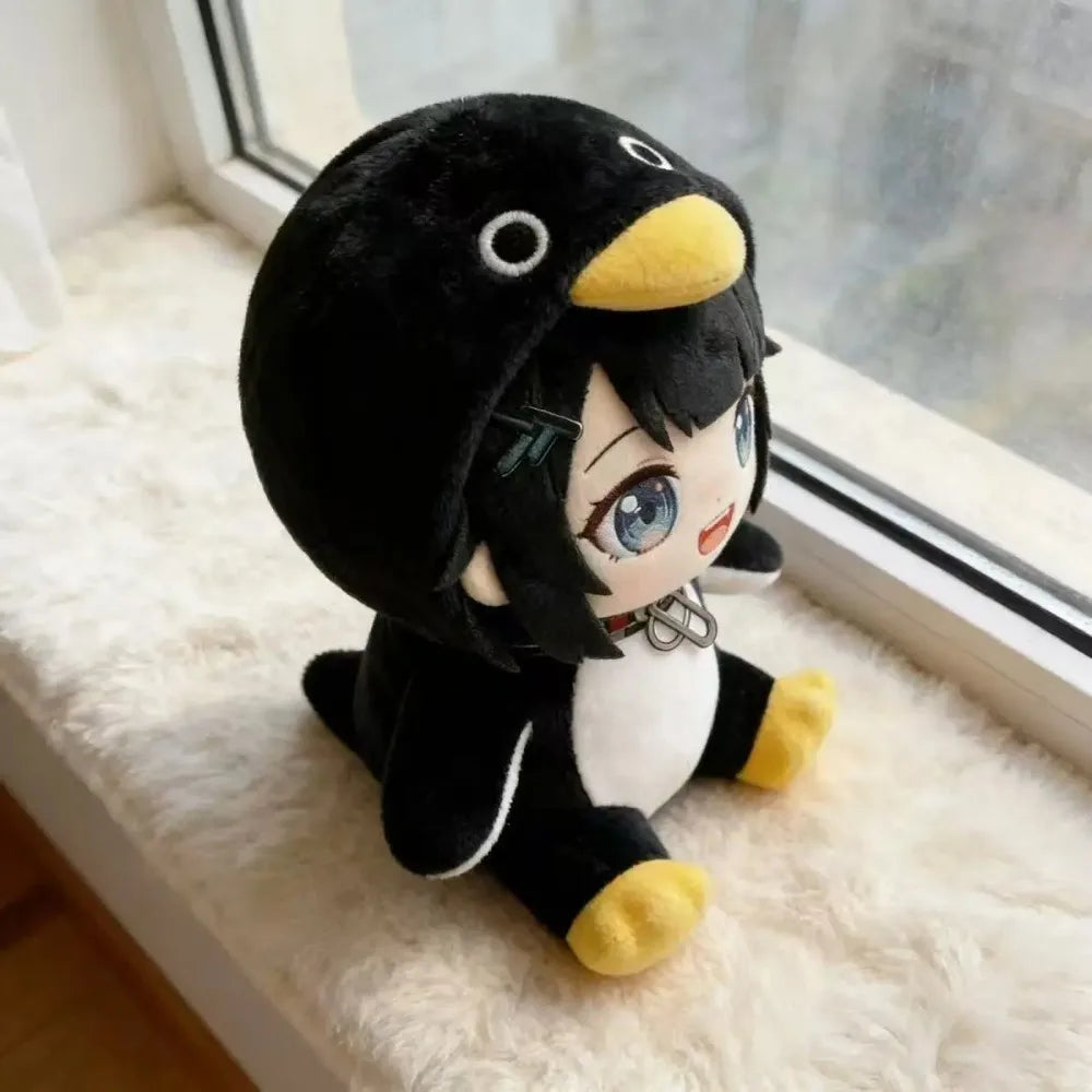 A cute kawaii penguin plush doll with black and white fur and yellow accents sitting on a white fluffy surface.