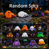 A collection of five random mini creepy-cute monster spider and skeleton figurines in various colors like orange purple black